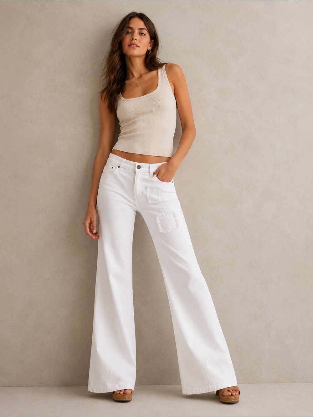 Paige Premium Denim Flare jeans in a white wash, featuring distressed patches